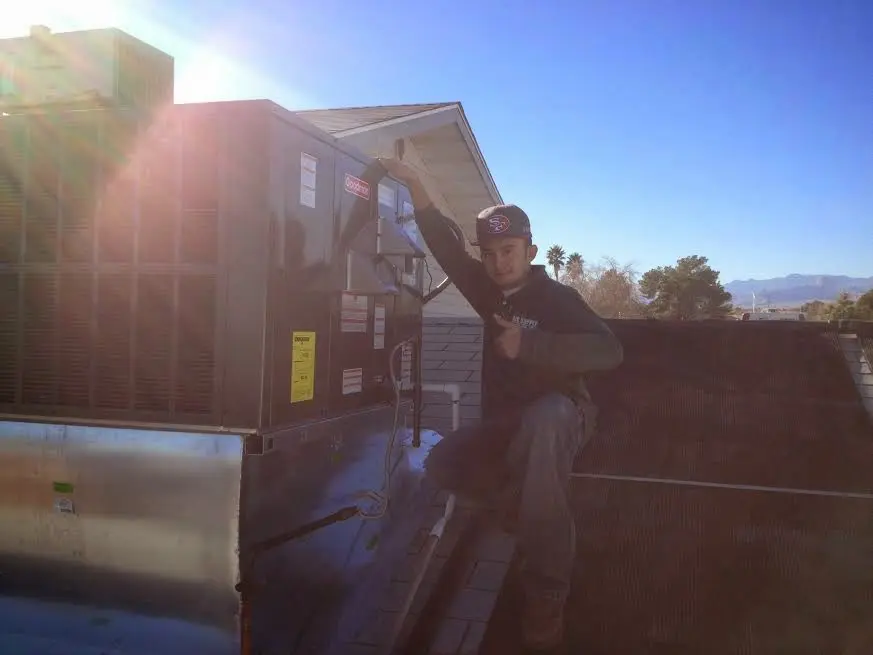 HVAC technician performing AC Tune-Up on a rooftop unit in Jonesborough